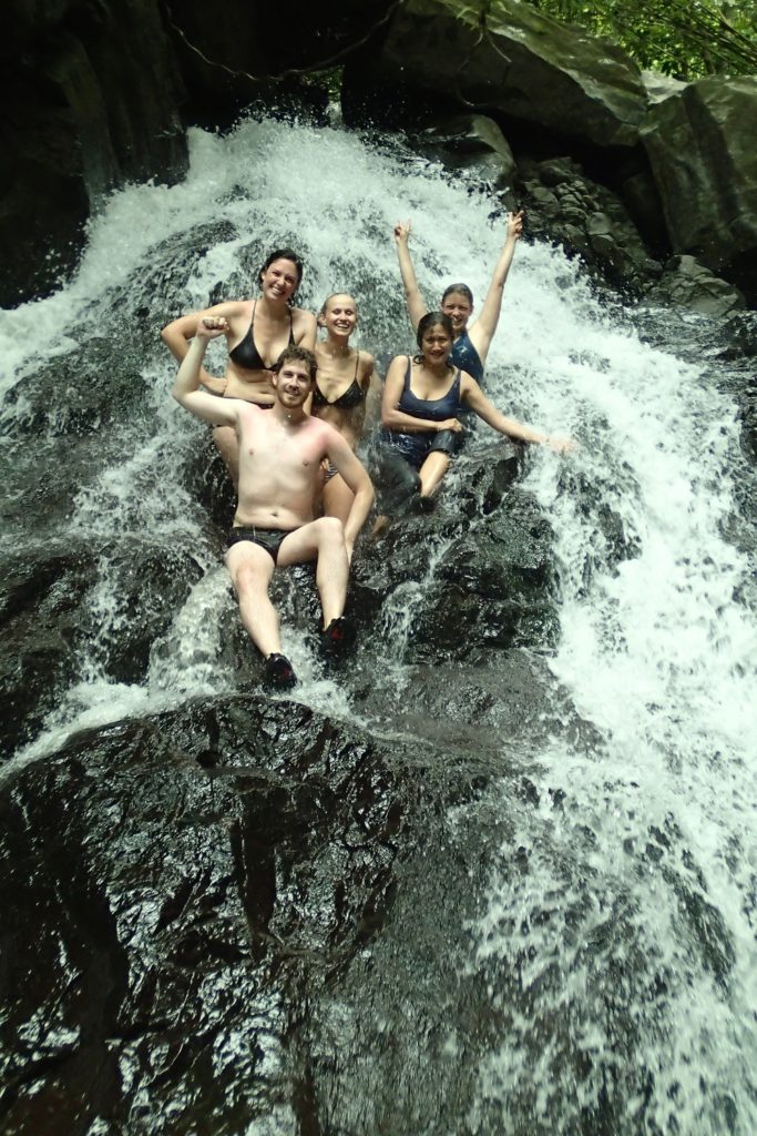 Sitting in a waterfall is all part of the fun Fiji activities